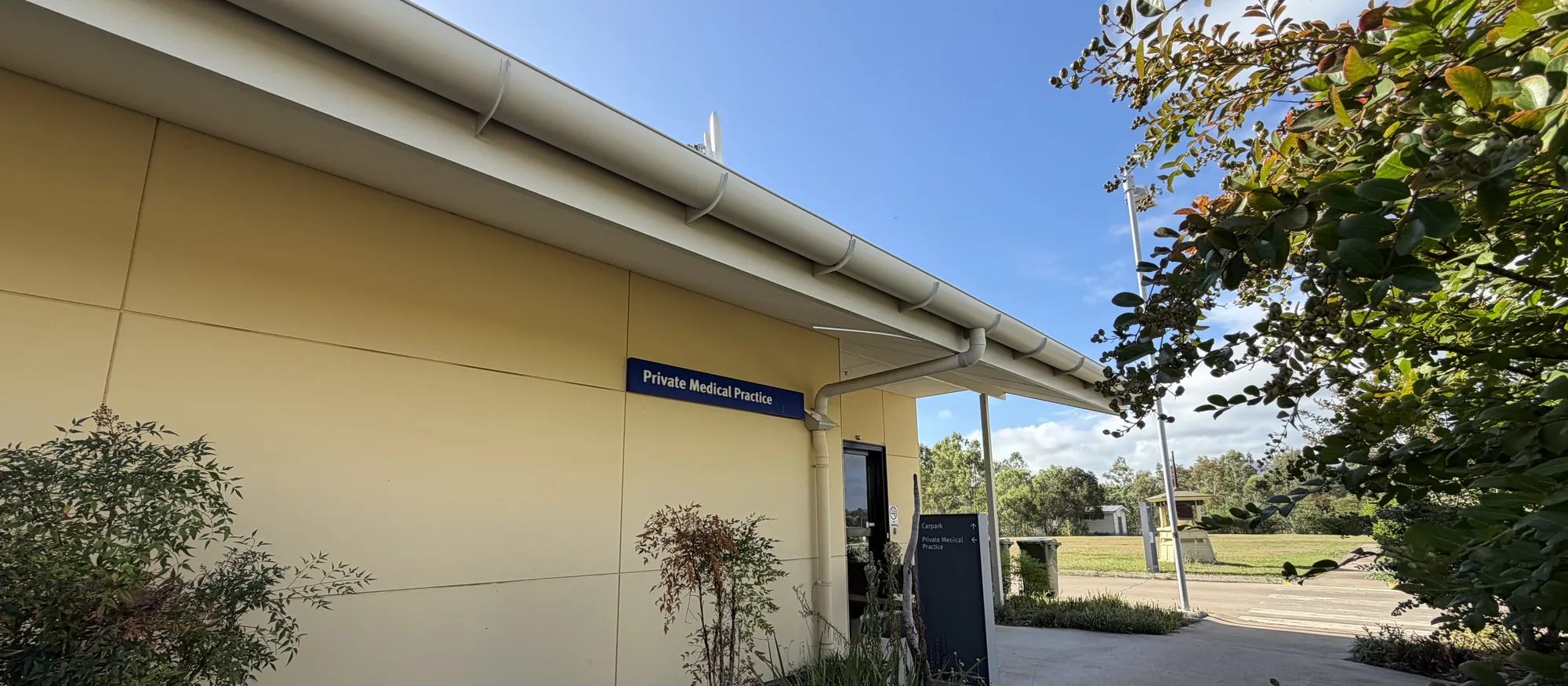 The practice building on Alice Street, with gardens and the Private Medical Practice sign